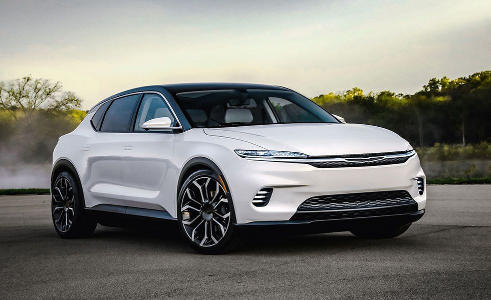 White electric SUV parked on a road at sunset, front three-quarter view.