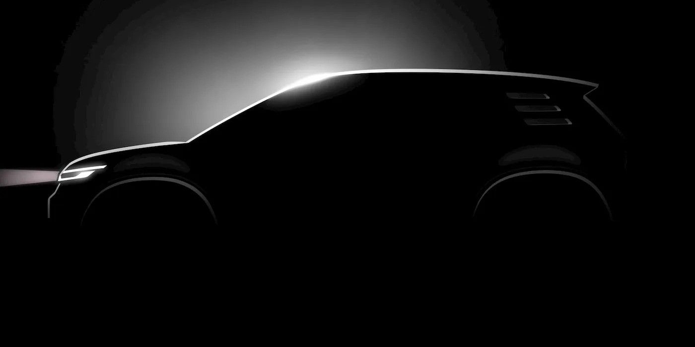 Silhouette of a black car against a bright circular backlight, side view in darkness