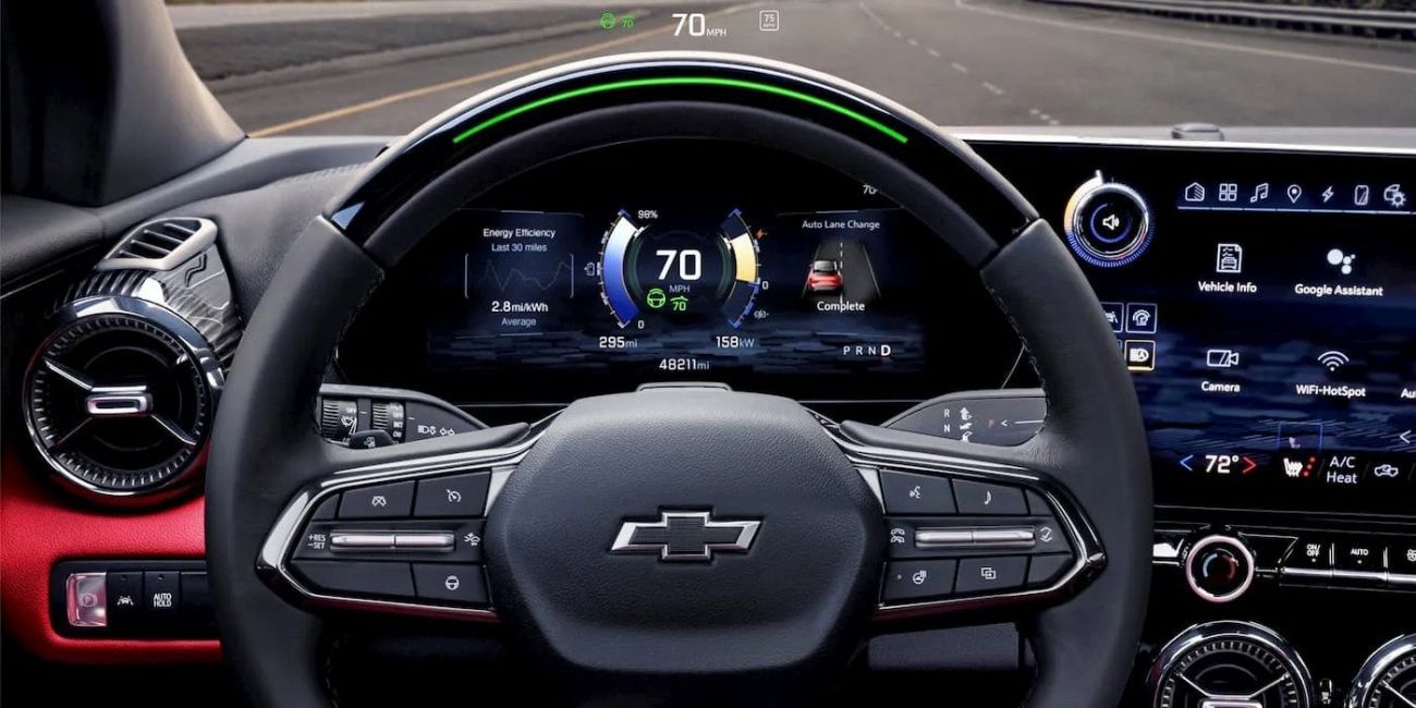 Chevrolet car dashboard and steering wheel, with digital speedometer showing 70 mph and infotainment screen on the right
