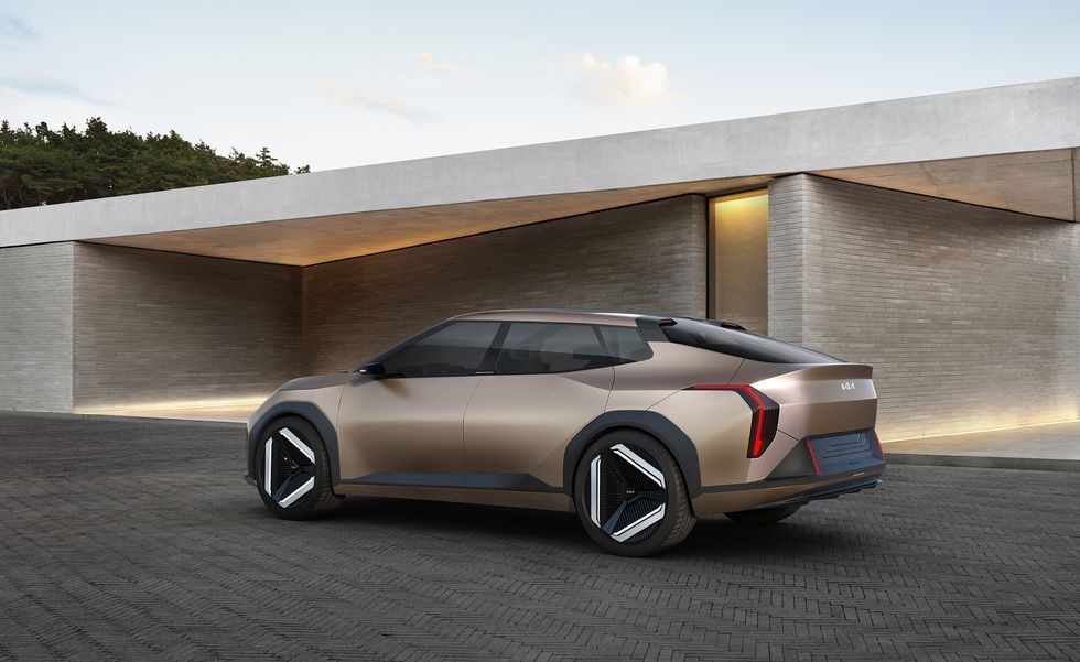Silver concept SUV parked in front of a modern minimalist house at dusk