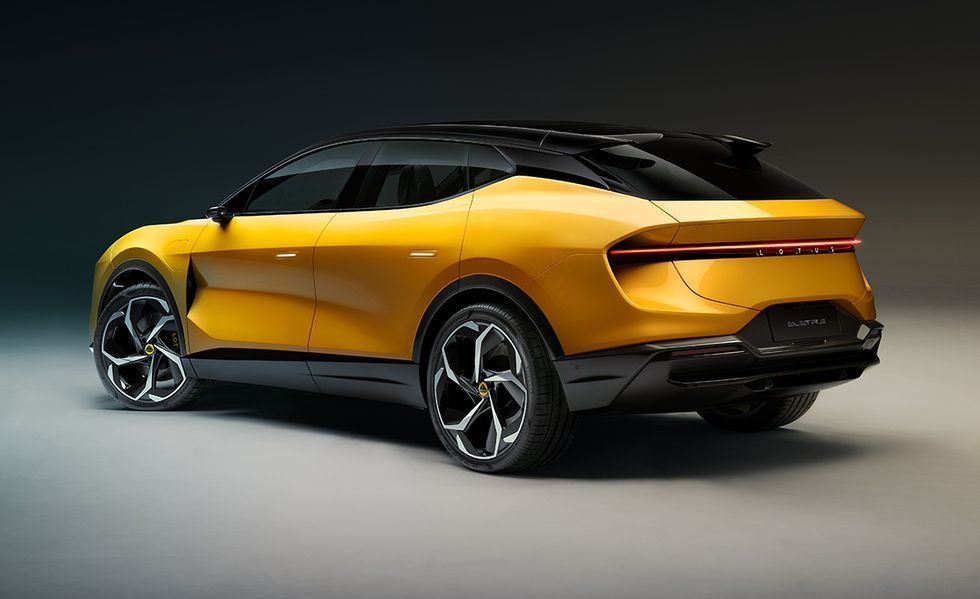 Yellow futuristic SUV concept car in studio, side rear view with black roof and alloy wheels
