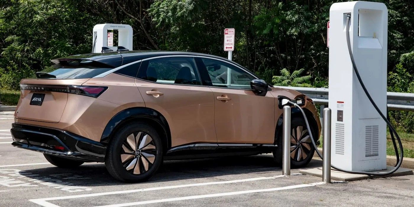 Copper electric SUV charging at a public station outdoors