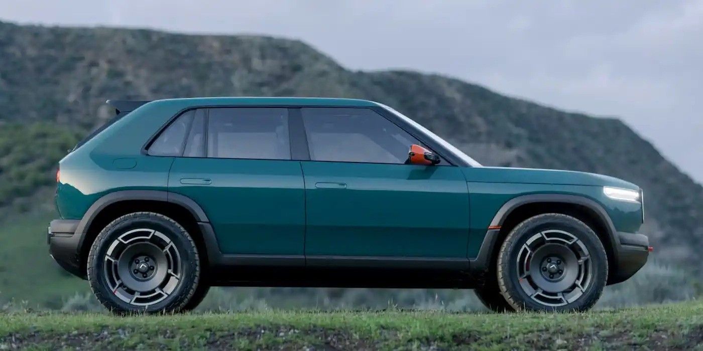 Teal compact SUV parked on a road with mountains in the background