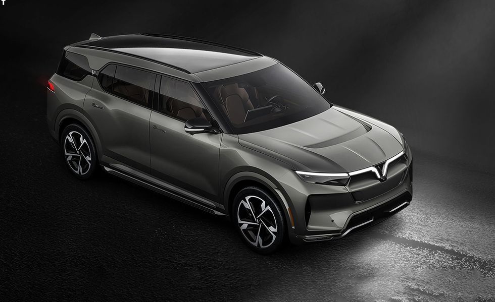 Sleek silver SUV concept car on a dark studio background, viewed from above.