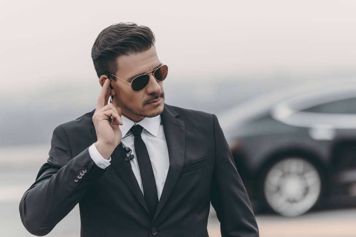 Private security specialist communicating via earpiece.