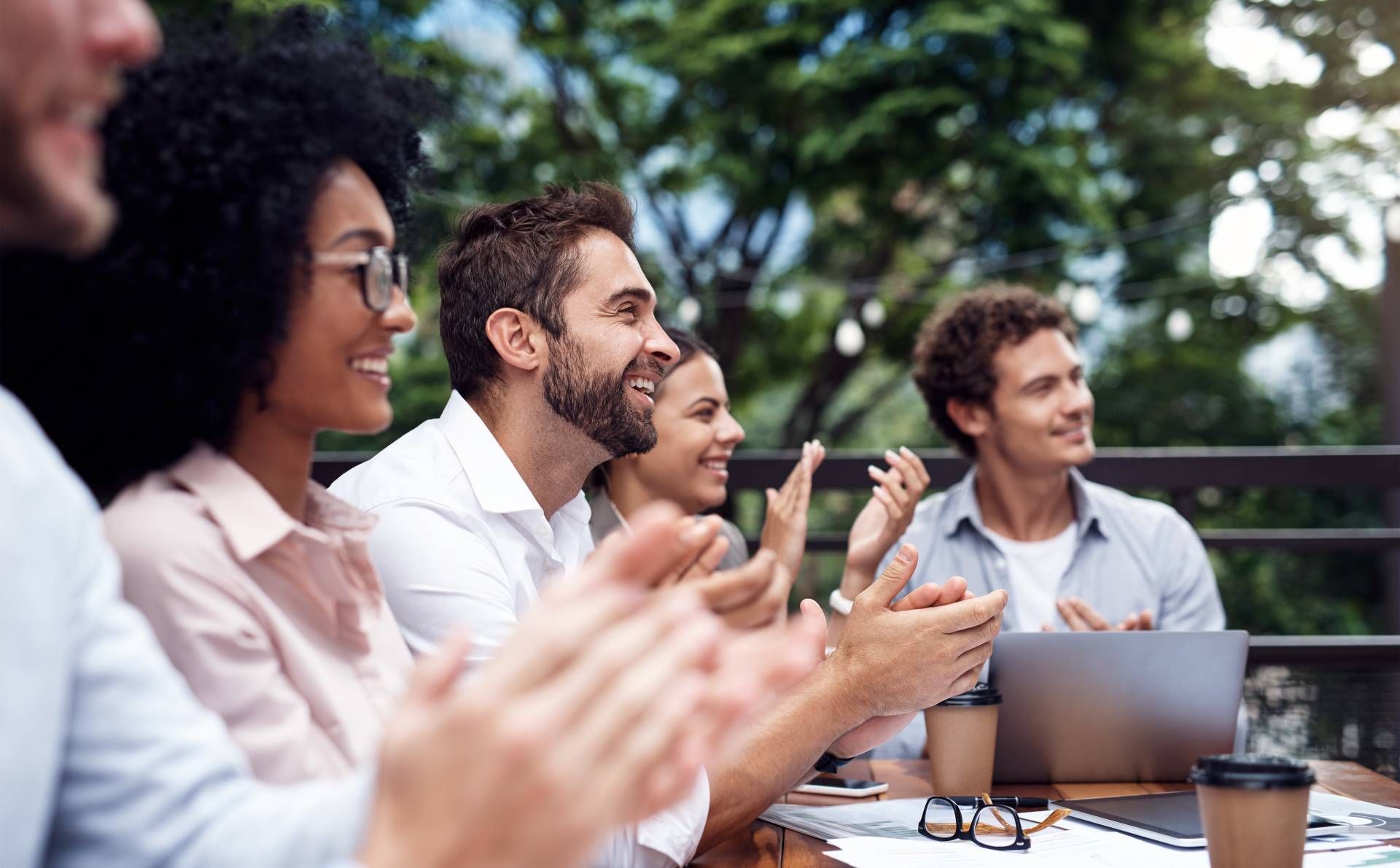 Several company team members sitting around a table at a corporate retreat.