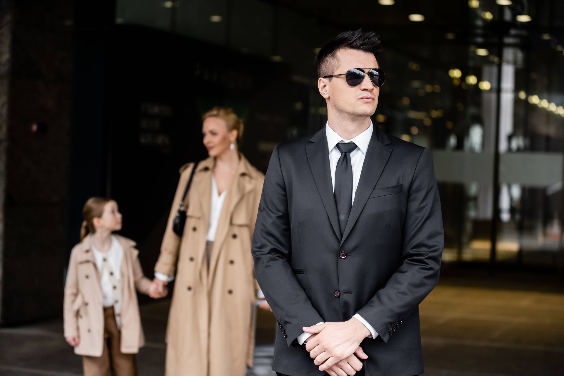 Security professional standing beside woman and daughter