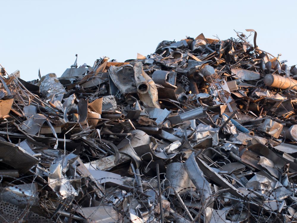 Pile of Scrap Metal Against a Light Blue Sky — B & B Scrap Metal in Maroochydore, QLD