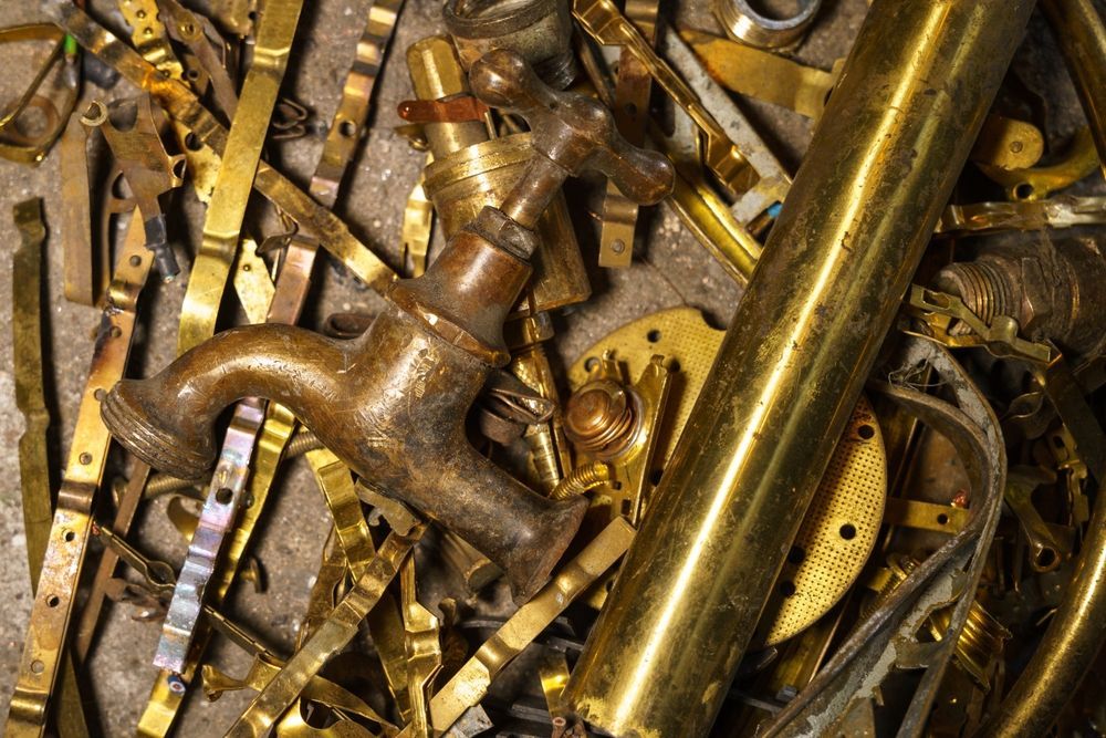 Pile of Brass and Bronze Scrap Metal, Including a Faucet and Pipes  — B & B Scrap Metal in Noosaville, QLD