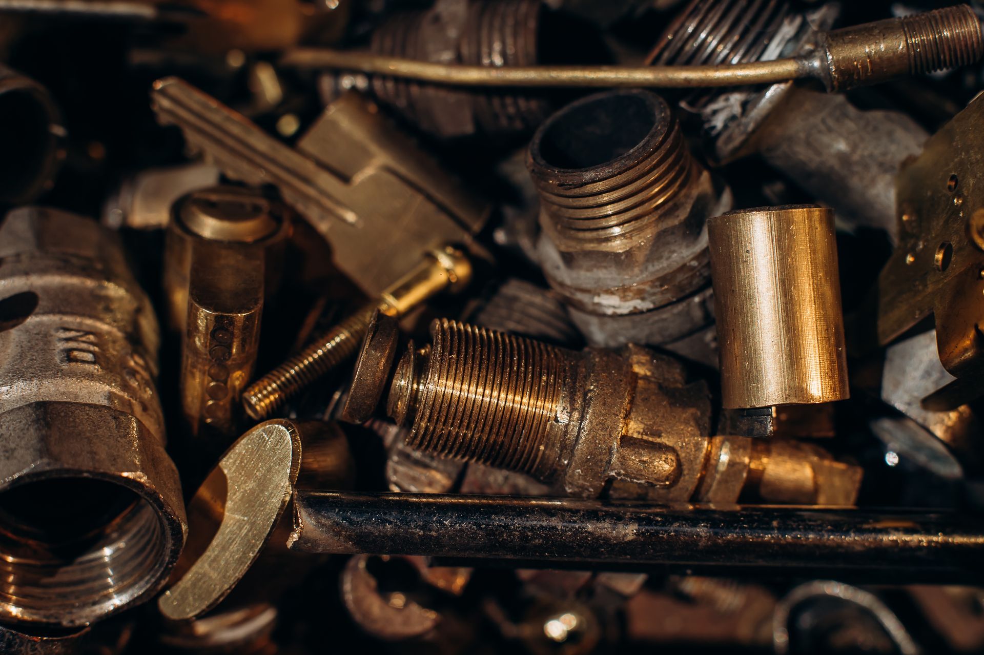 Pile of Various Brass Plumbing Fittings, Close-up — B & B Scrap Metal in Noosa, QLD
