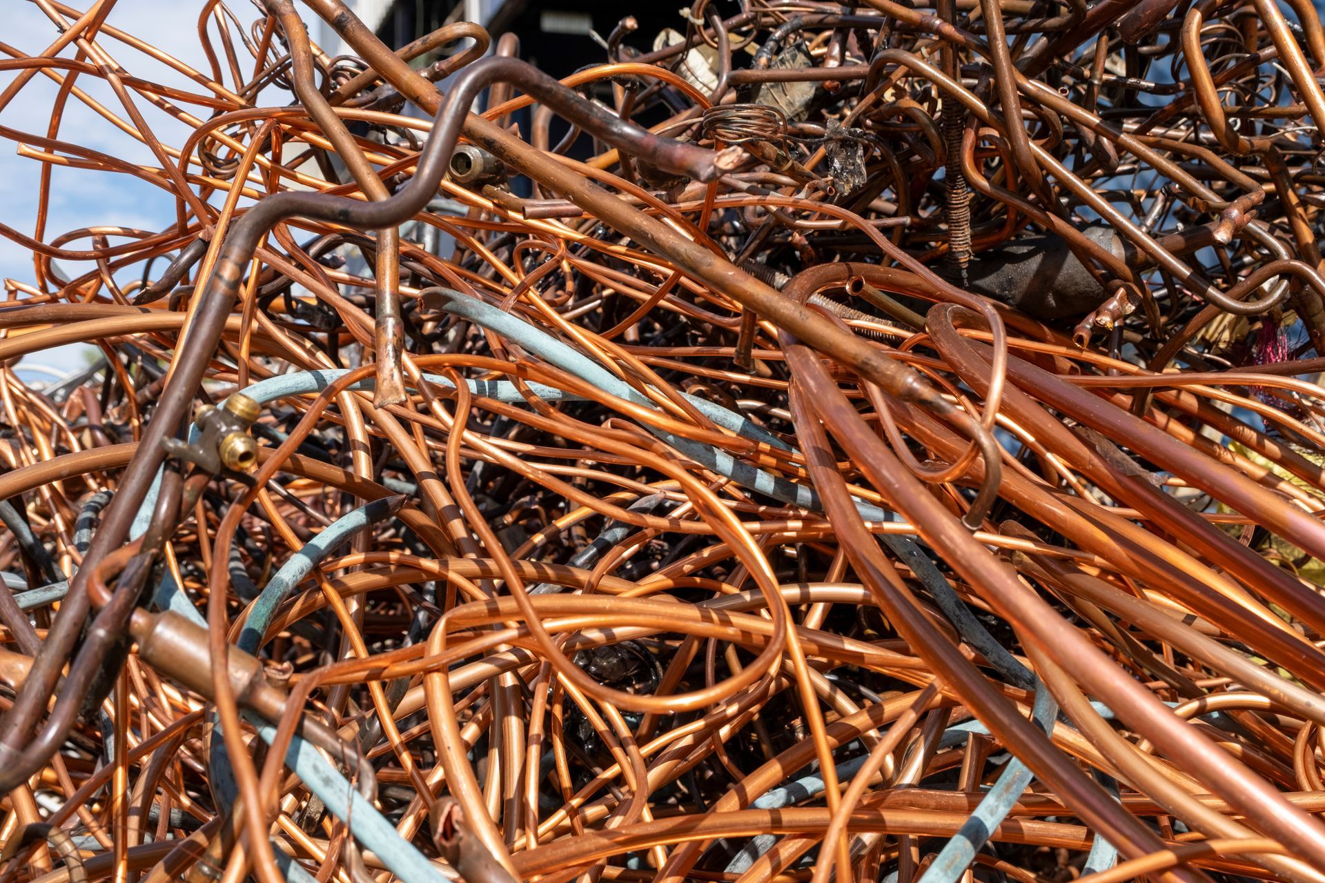 Pile of tangled copper tubing, various shades of brown and orange.