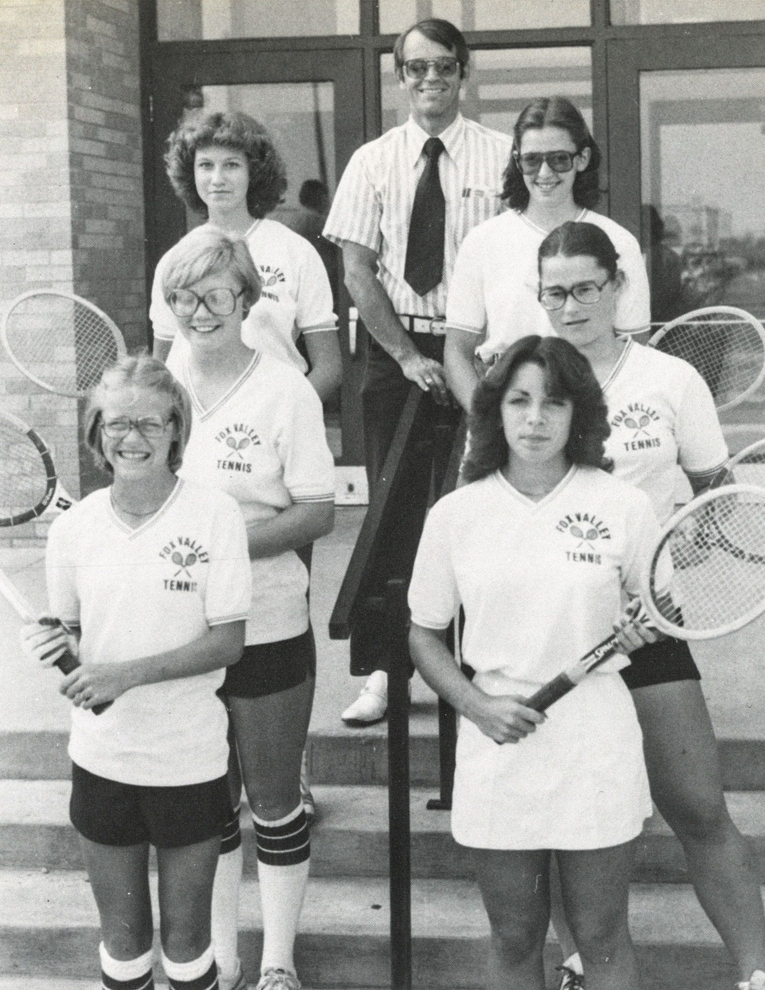 Rev. Gorske on the steps with the girls tennis team