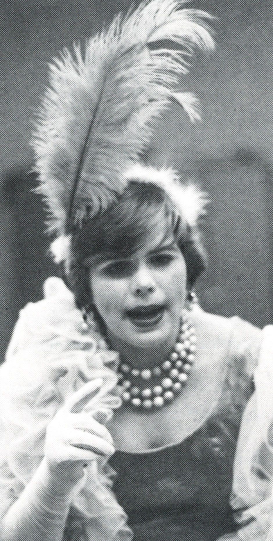 Female student in costume - with feathered hat, pearls, and fur coat