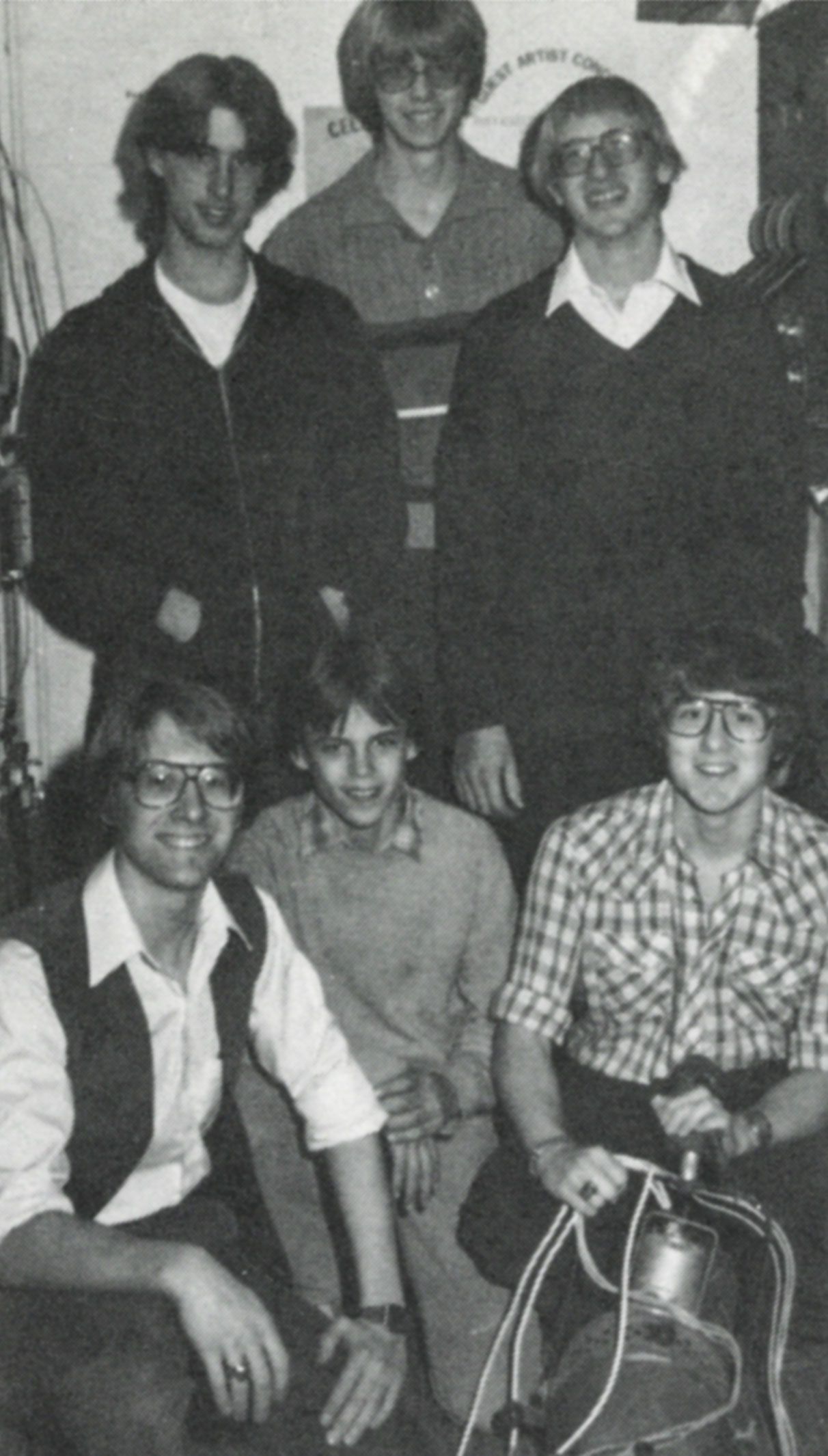 Six students together with one holding a light