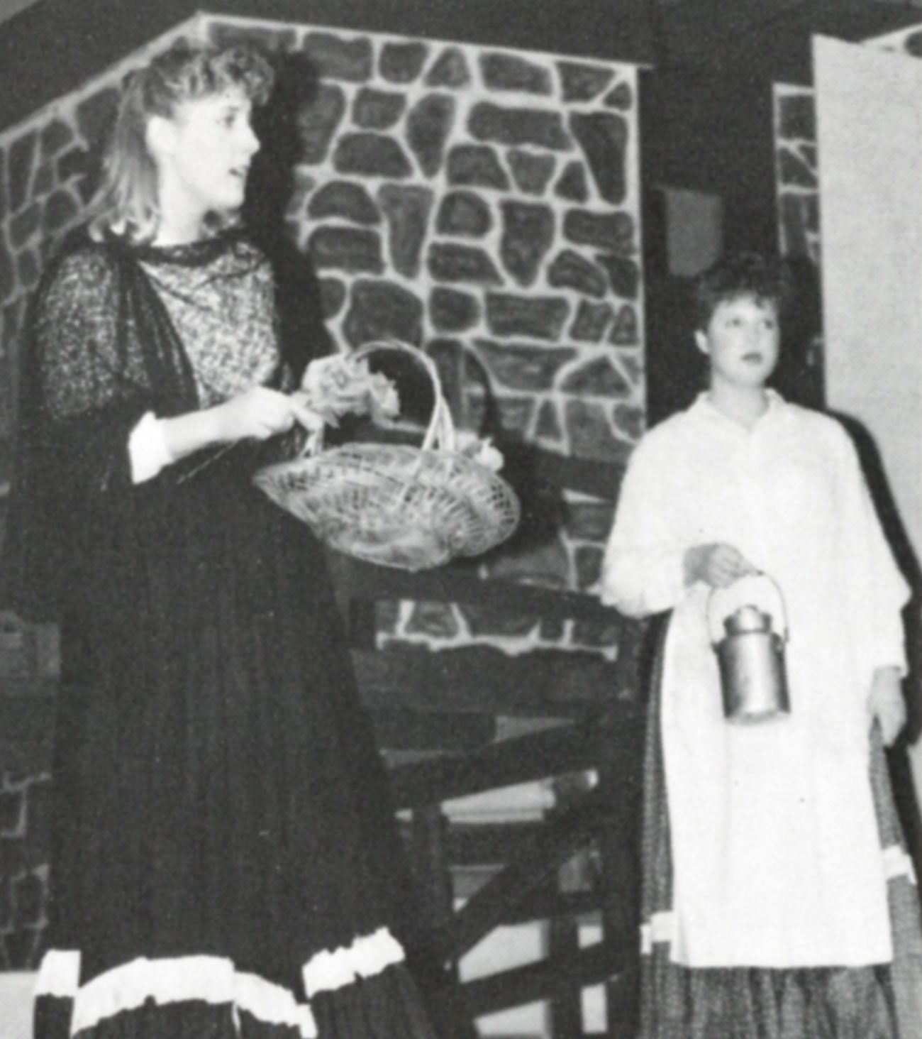 Female holding a basket with brickwork in background