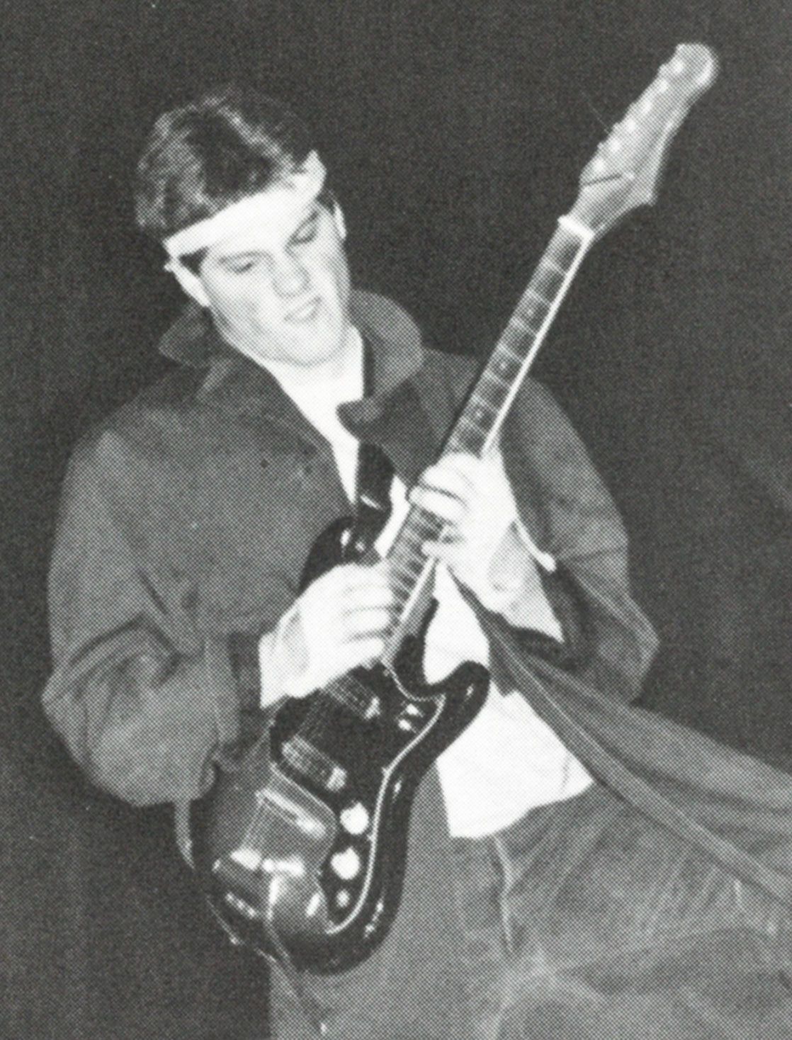 Male student with electric guitar, performing on stage