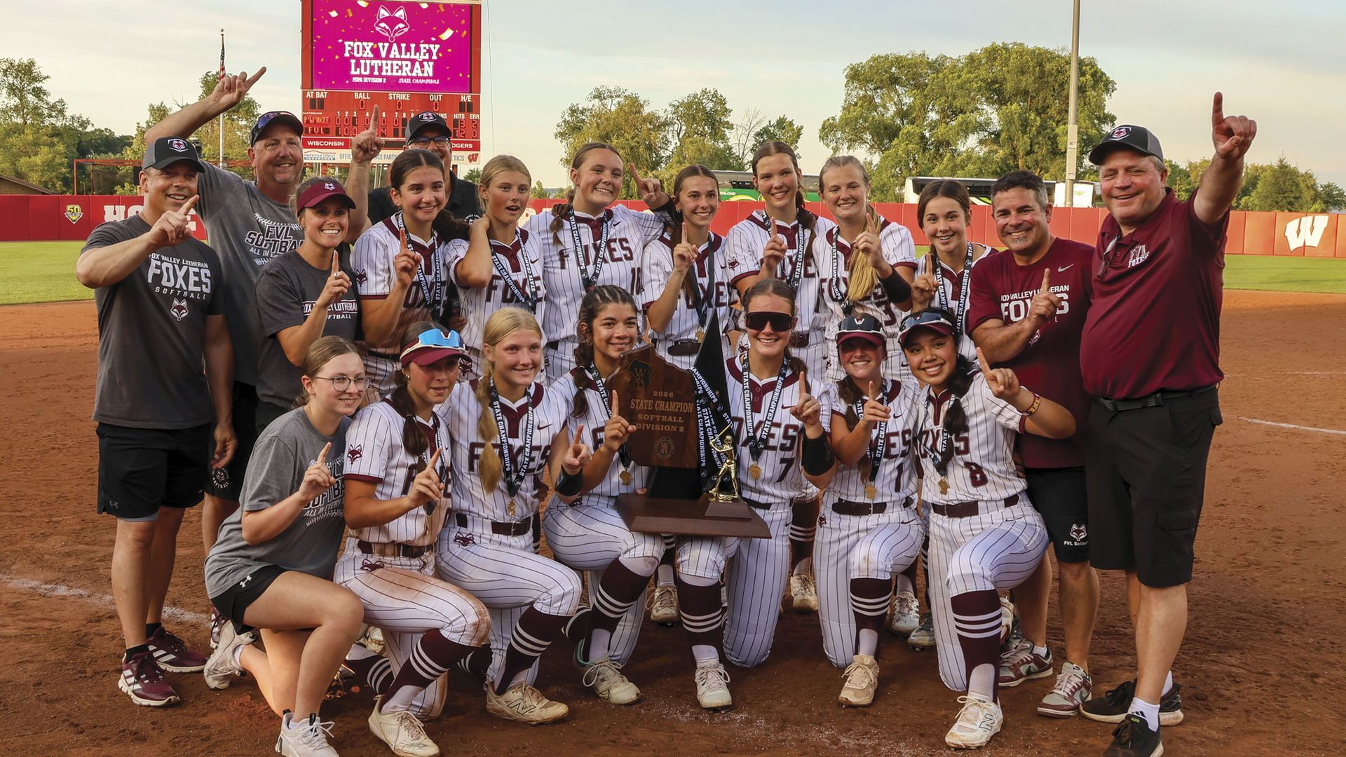 Softball team after winning State Championship - all holding up their pointer finger
