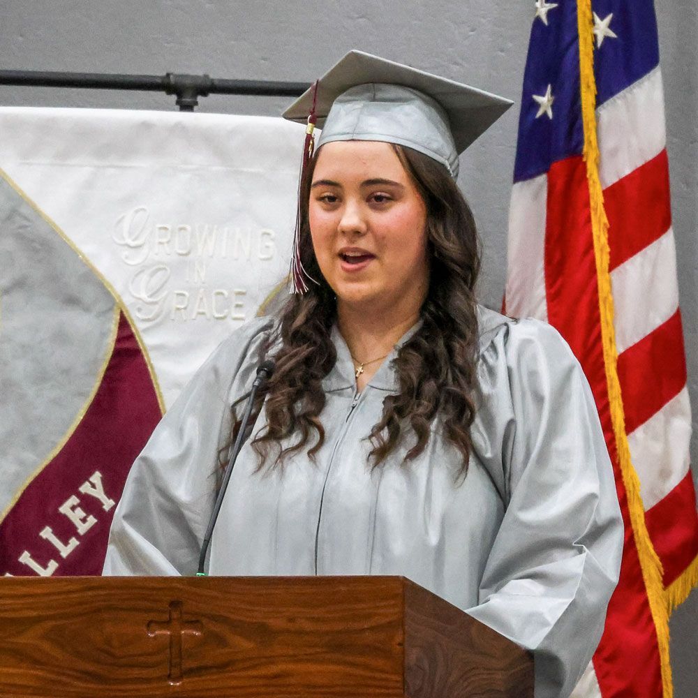 Katelyn is at the podium in her cap and gown, giving her graduation speech