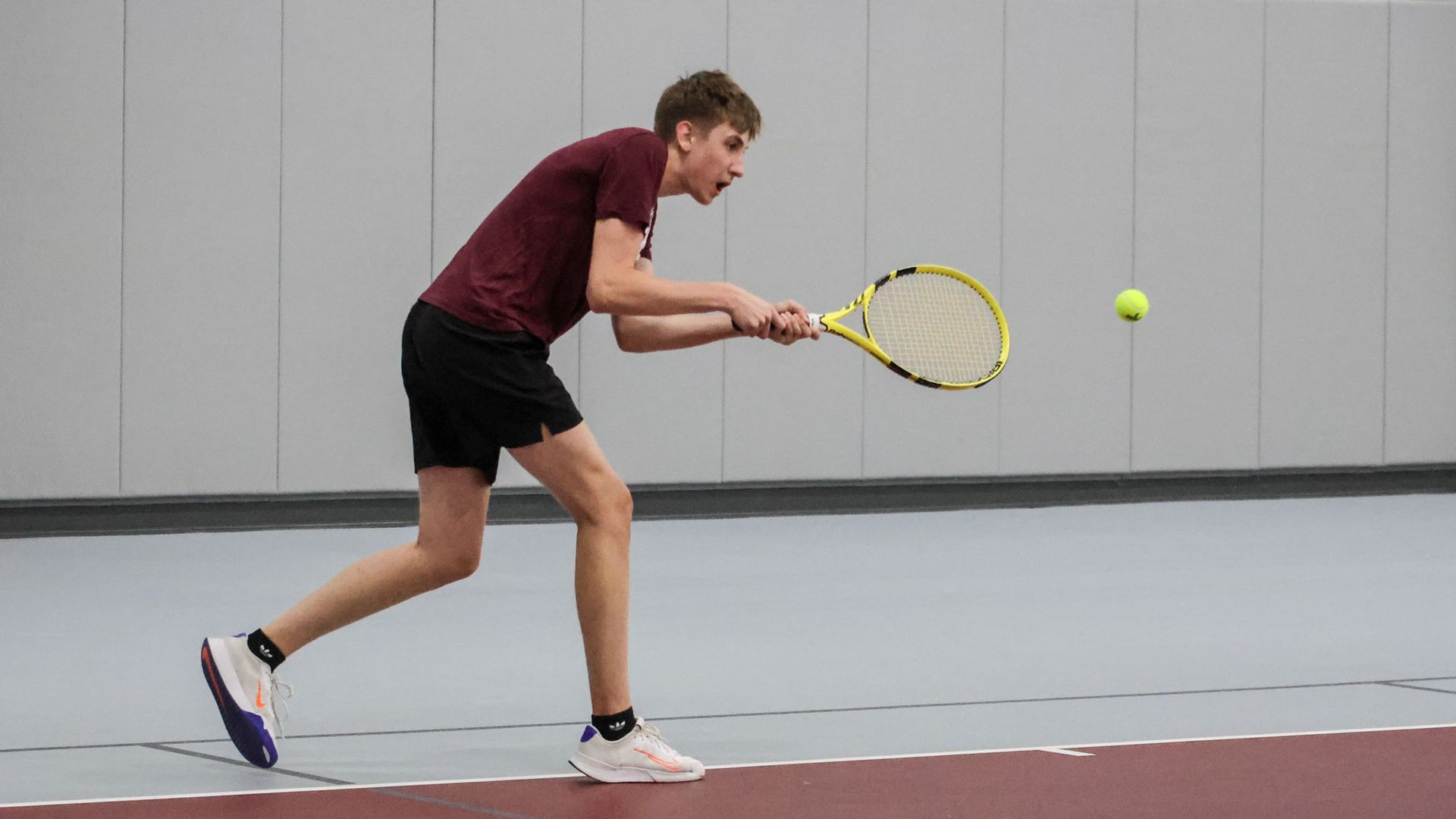Male tennis player hitting the ball