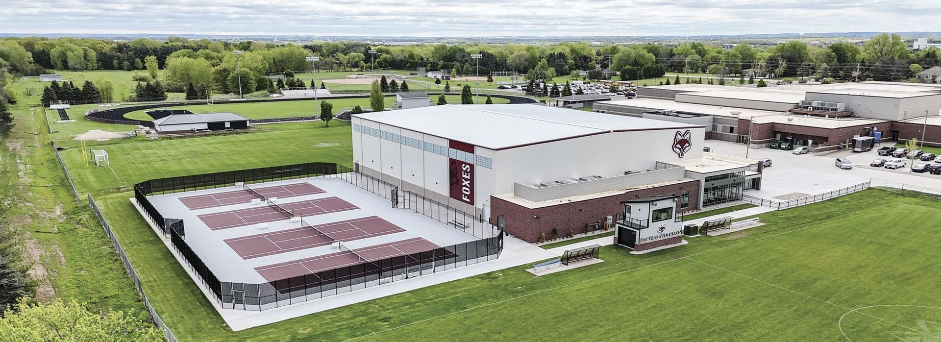 Drone shot of Timothy Trout Sports Center from the outdoor tennis courts side of the building