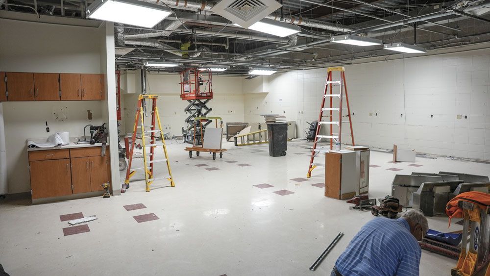 FACE room with tables, chairs, and celing tiles removed