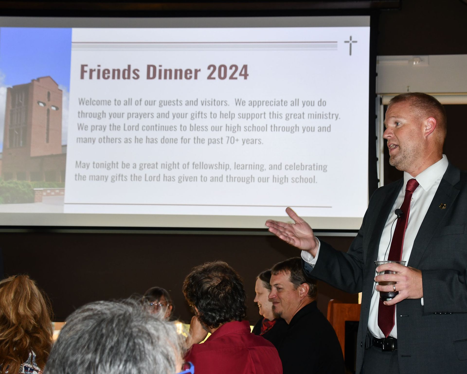 President Loberger with a microphone held out to a female attendee