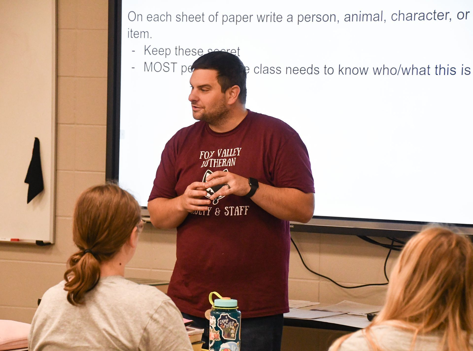 Ben Perushek teaching, with the smart board behind him.
