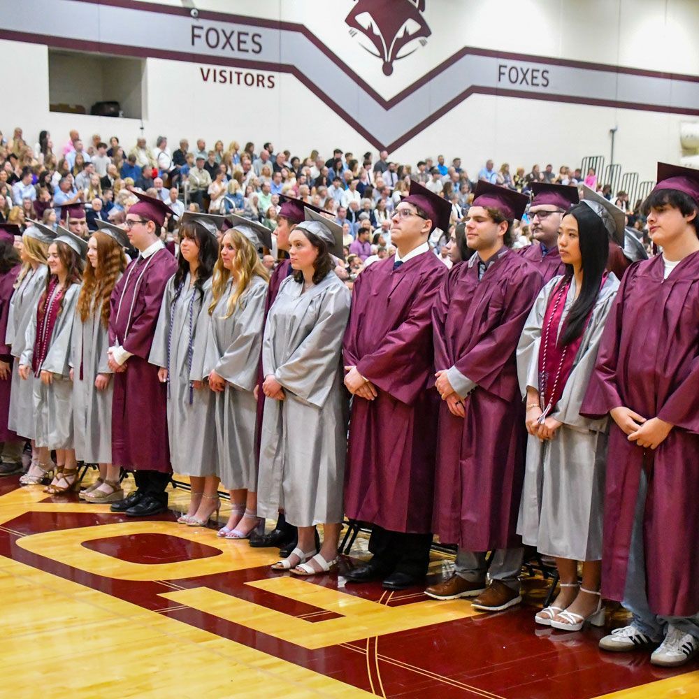 Students in places at the beginning of the graduation service