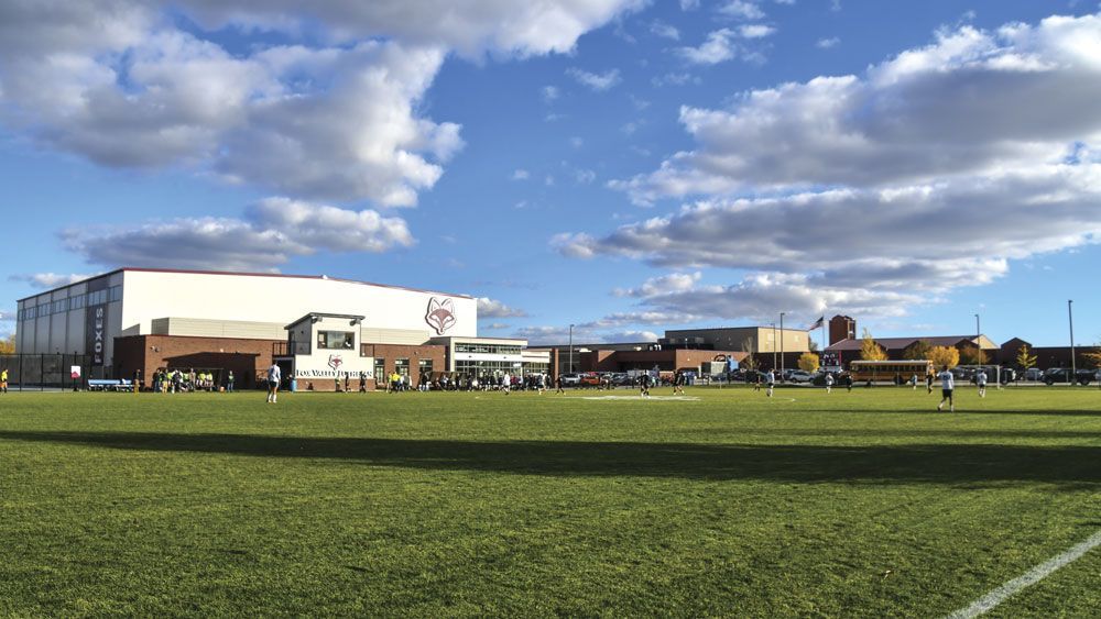 Looking from the soccer bleachers across the soccer field toward Trout Center and the school
