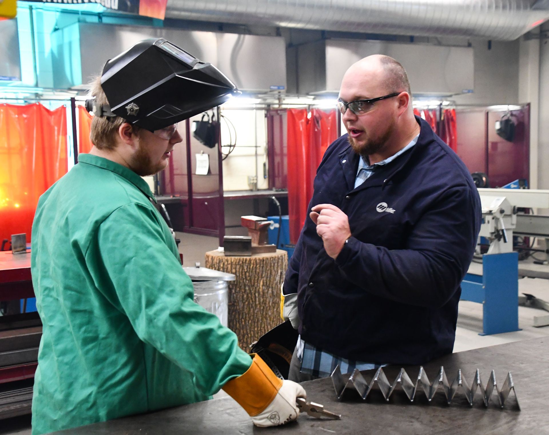 Jeremy in the welding lab, working with a student