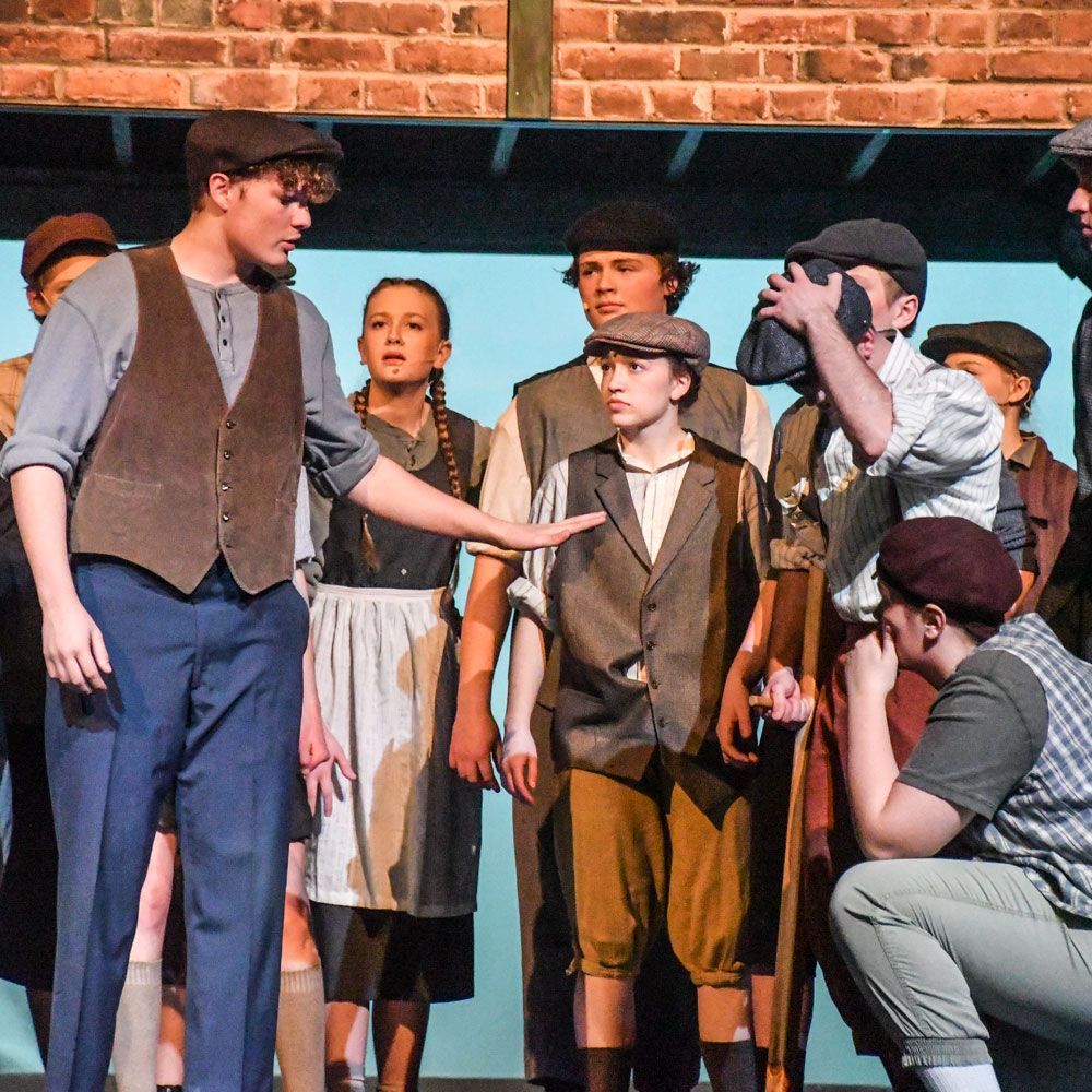 Student performing in Newsies