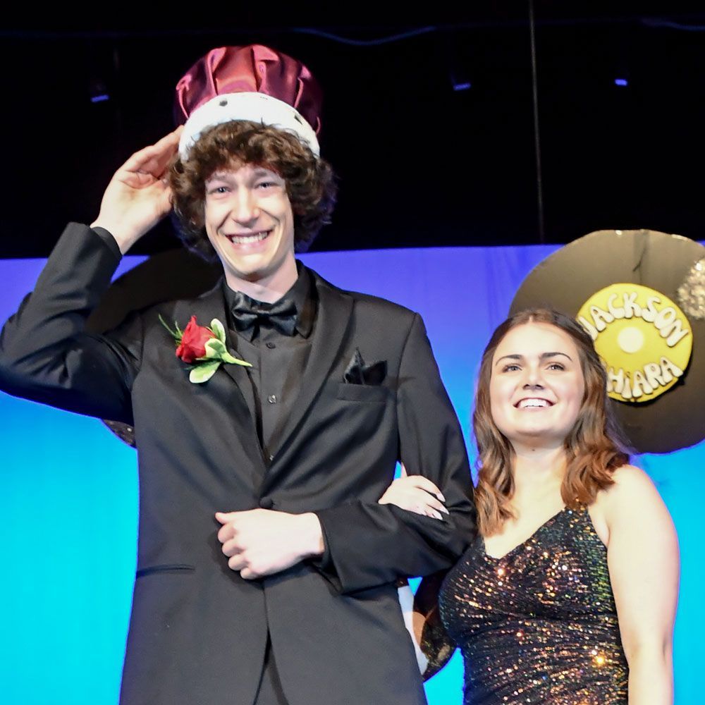 Prom King, Nicholas Kraftzenk, wearing his crown and with his escort, Miranda Buser, at his side