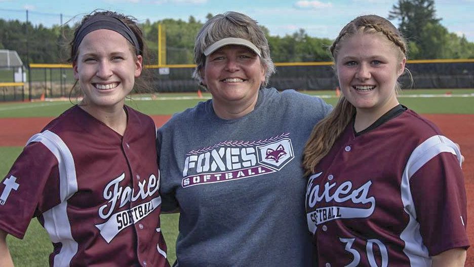 Two smilng FVL softball players with smiling Julie in the middle