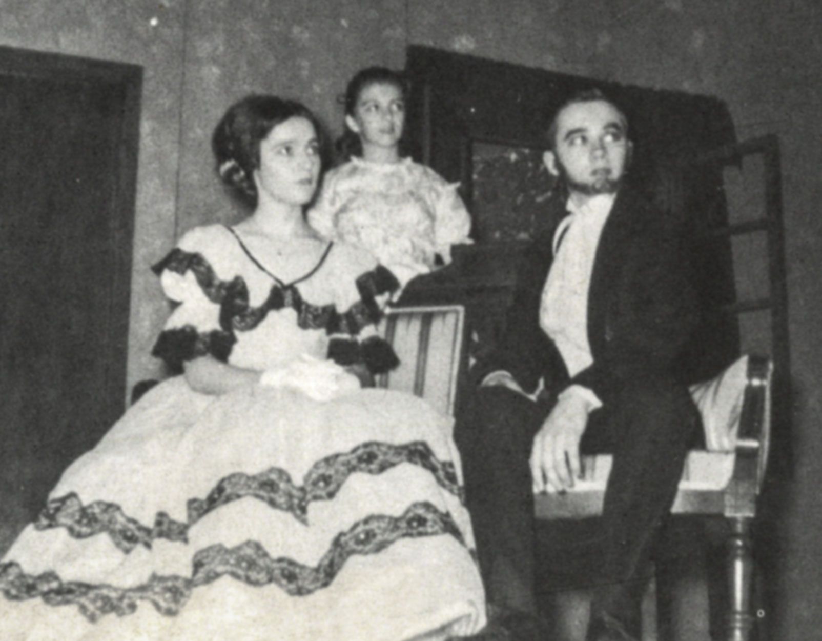 Female in vintage dress next to male in vintage suit