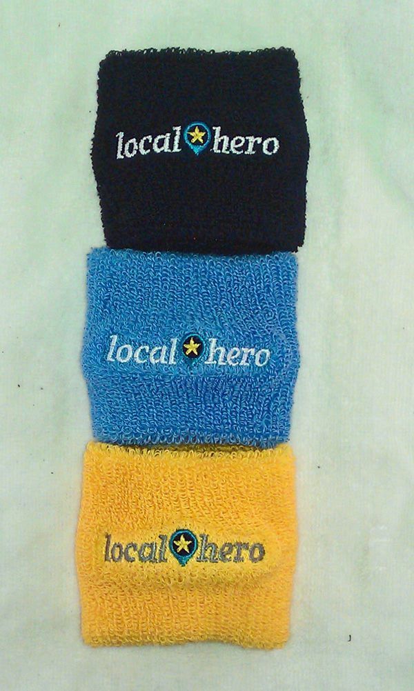 Three colorful sweatbands stacked: black, blue, and yellow. Each has 