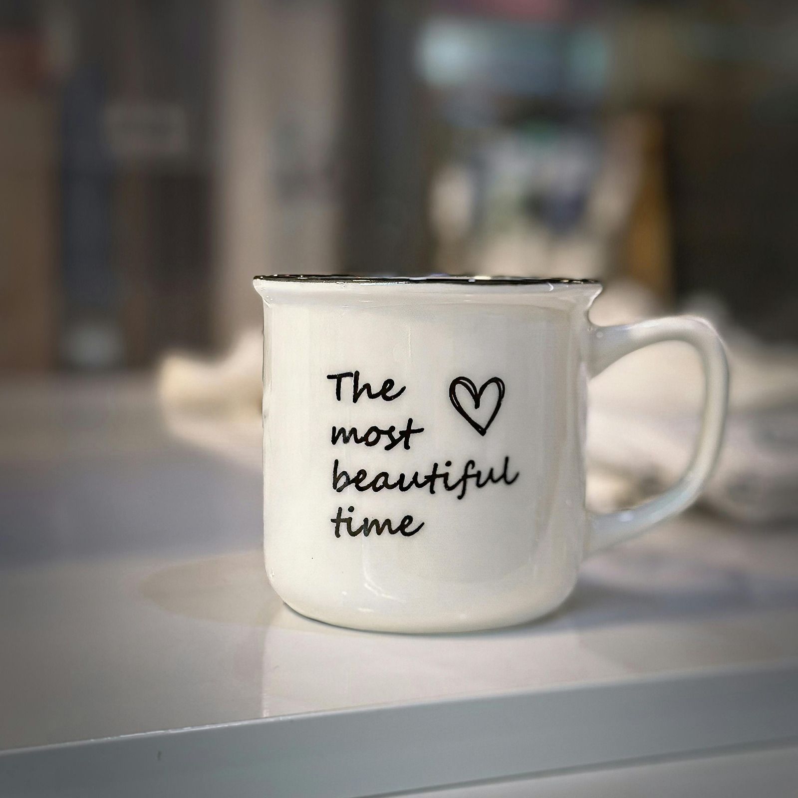 White mug with black text:
