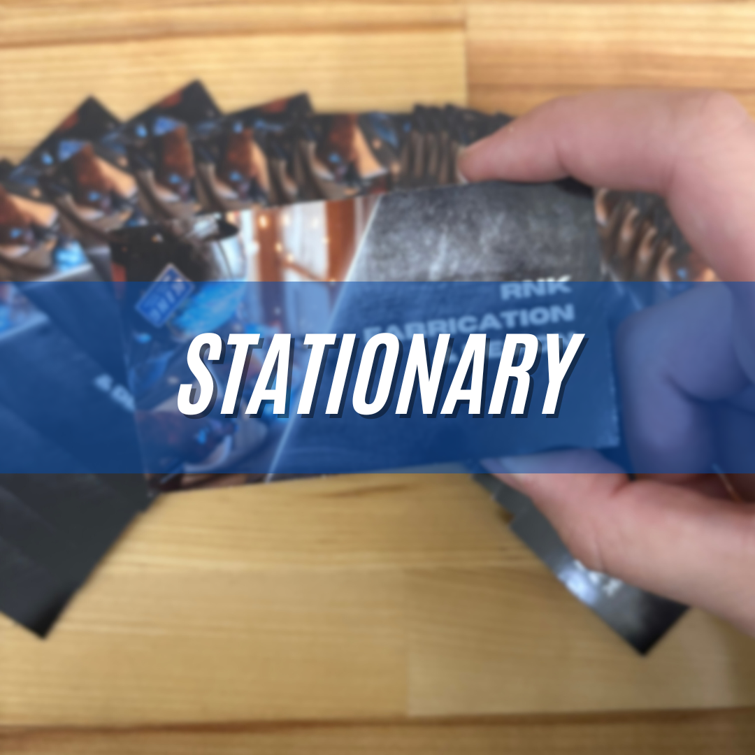 Hand holding a blue-packaged stationery item on a wooden surface