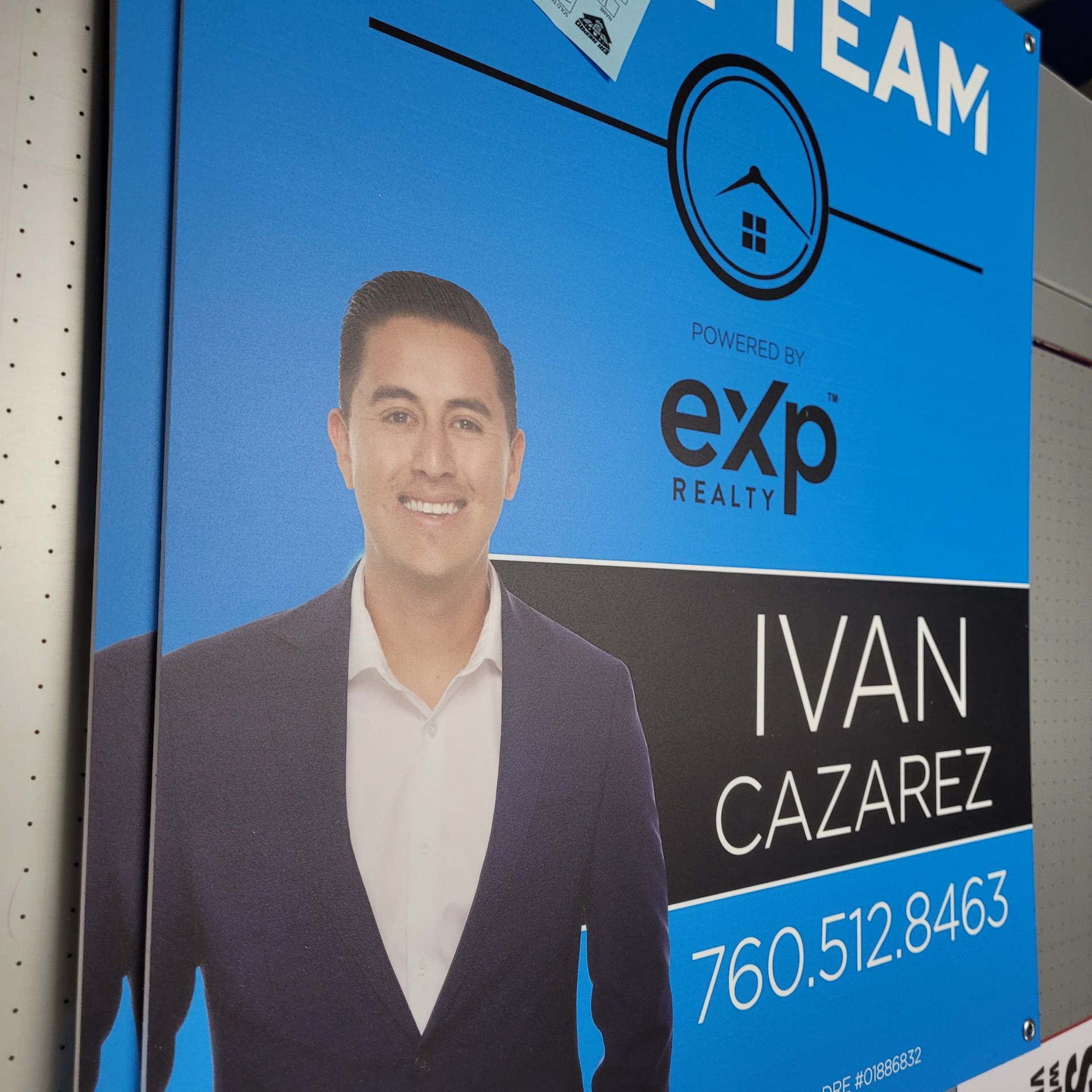 Real estate team sign with blue background, agent portrait, and the name Ivan Cazarez with phone number.