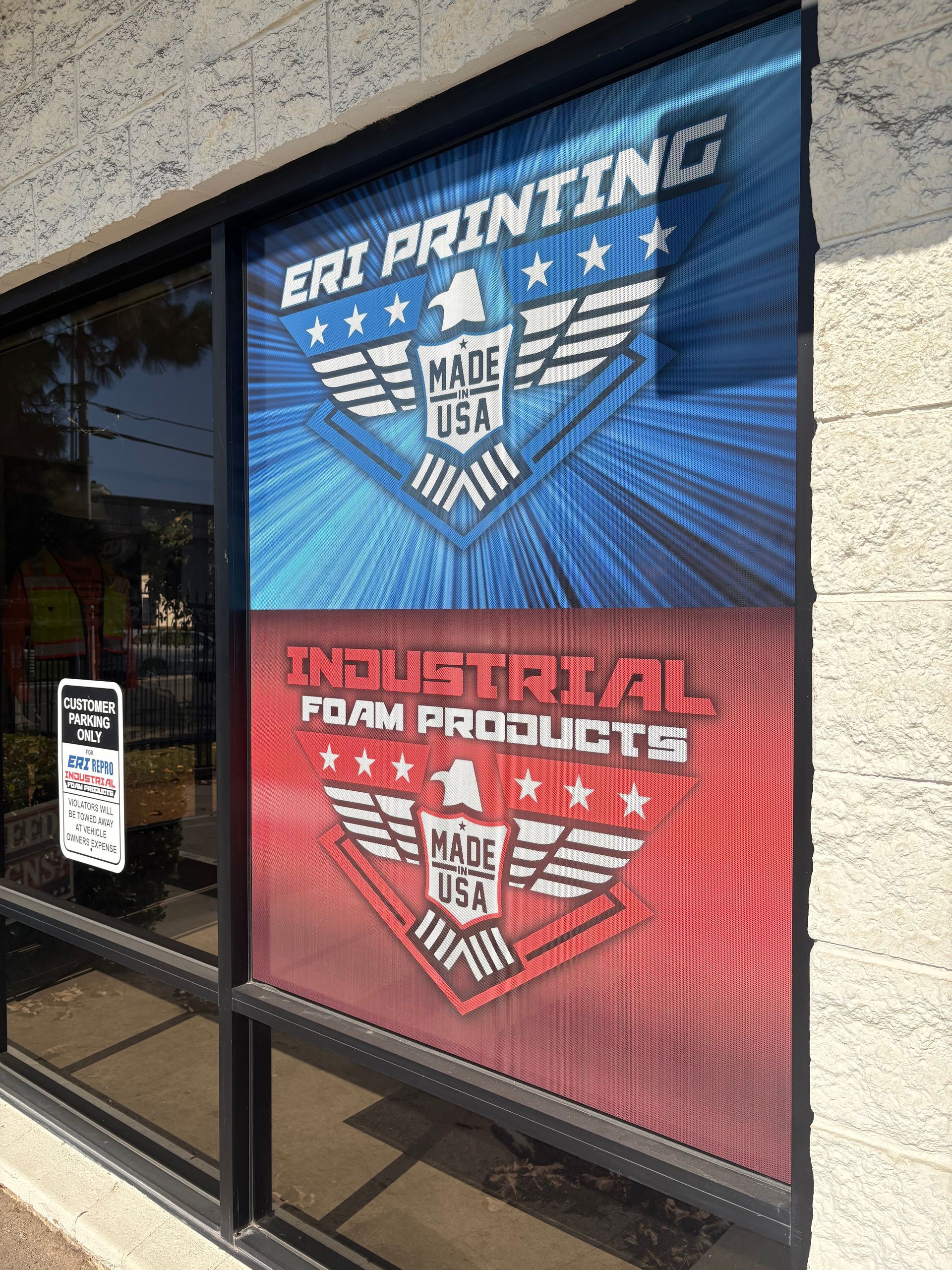 Storefront window decals advertising EMI Printing and Industrial Foam Products in blue and red.
