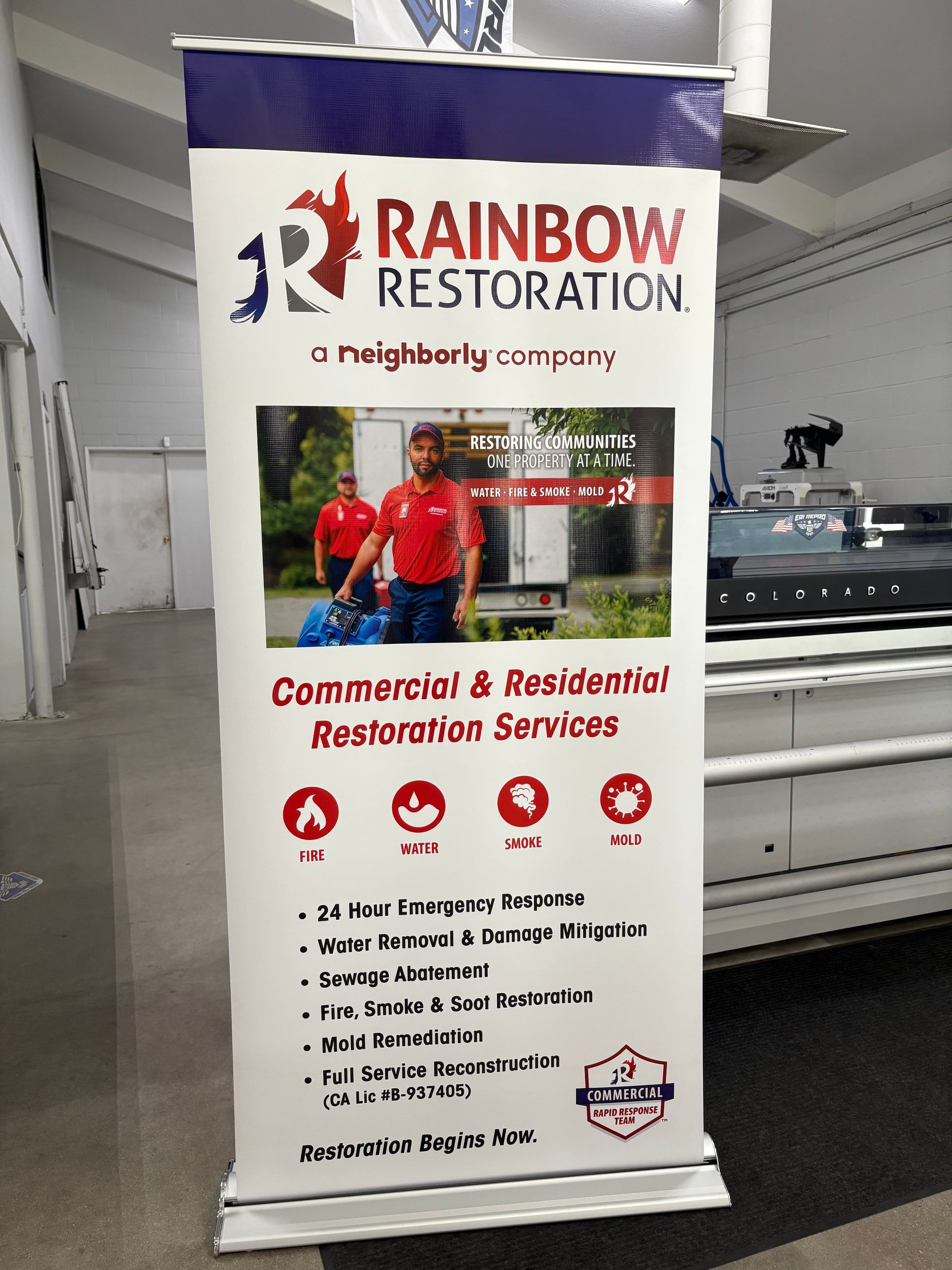 Rainbow Restoration banner for commercial and residential restoration services in a showroom.