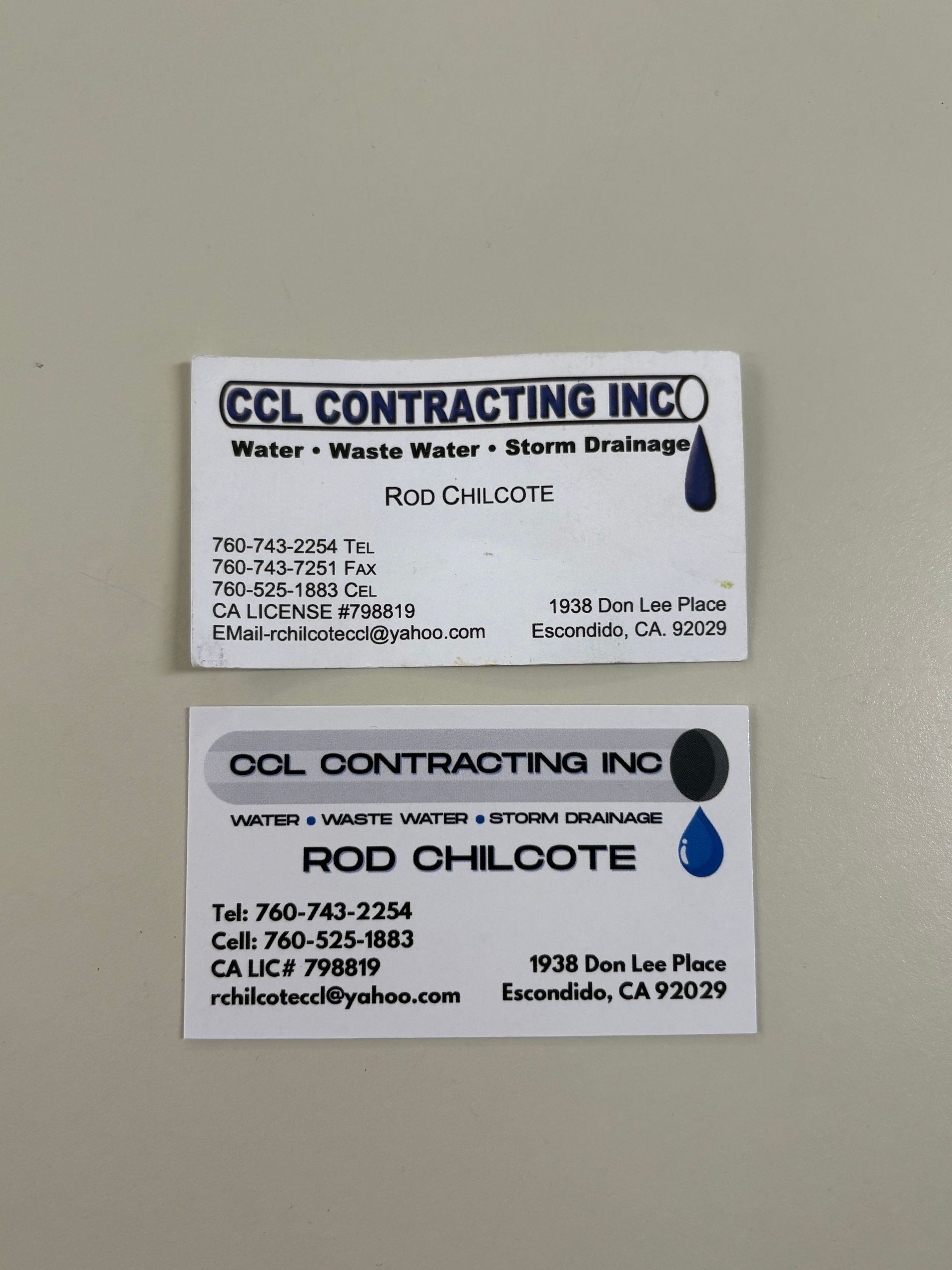 Two CCL Contracting Inc. business cards, one with a blue droplet logo on a gray background