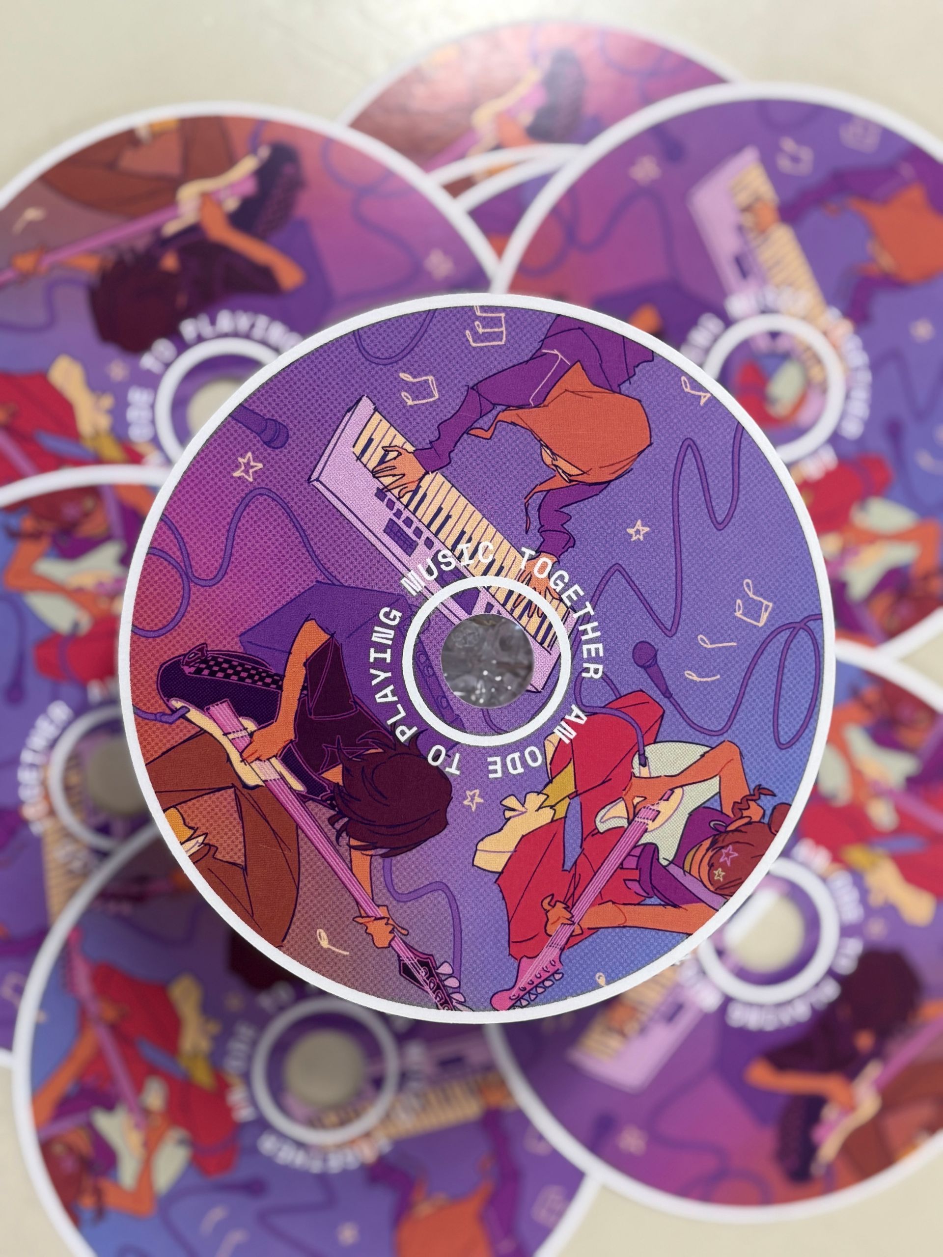 Purple and pink circular patterned discs with abstract figures, overlapping in a close-up view