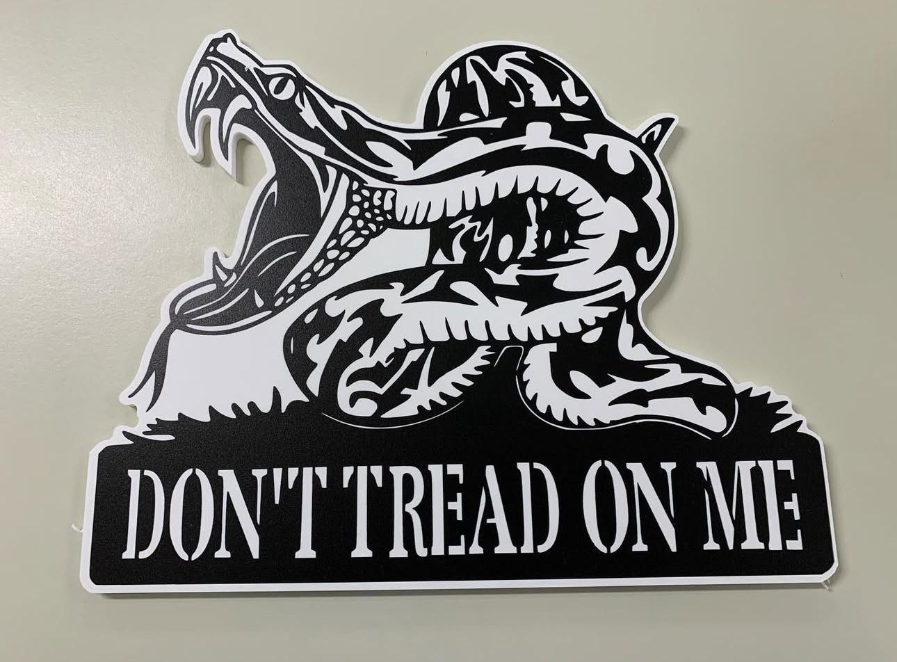 Black-and-white Gadsden flag sign with coiled snake and “DON’T TREAD ON ME” text