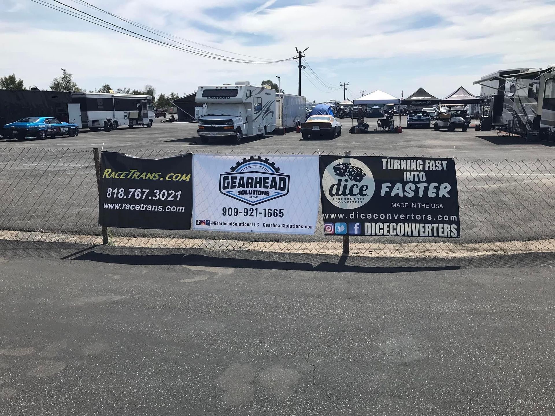 Outdoor lot with a large banner advertising towing, parts, and diesel services under a cloudy sky.