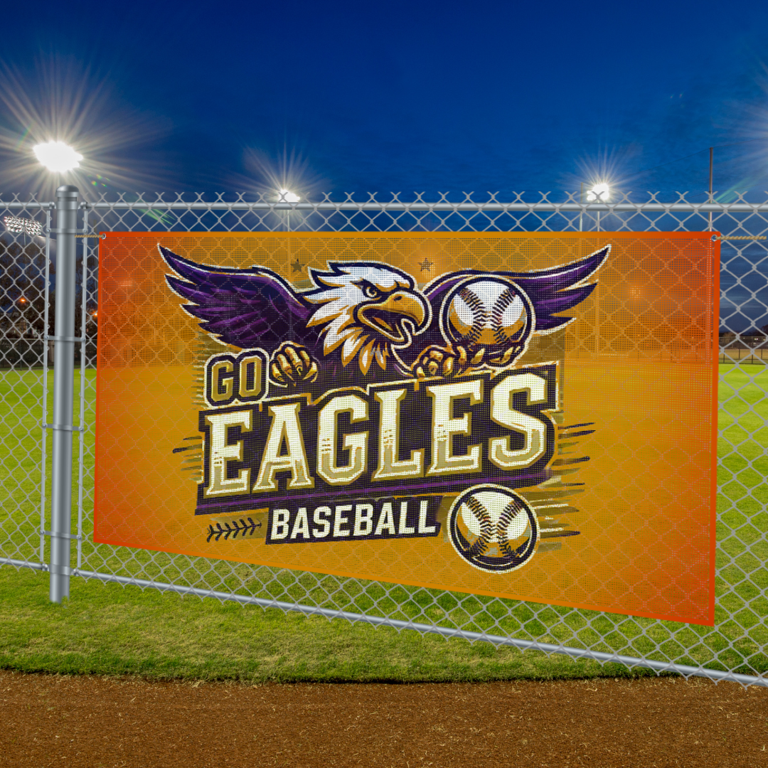 Orange Go Eagles baseball banner on a chain-link fence at a lit field at night