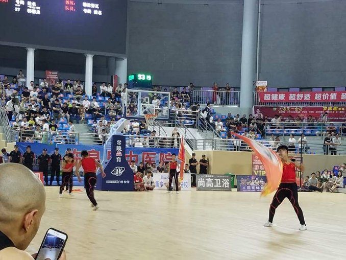 a man taking a picture of a basketball game