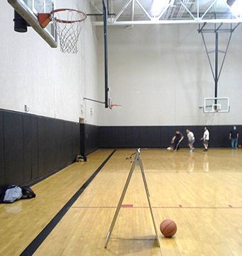 a man taking a picture of a basketball game