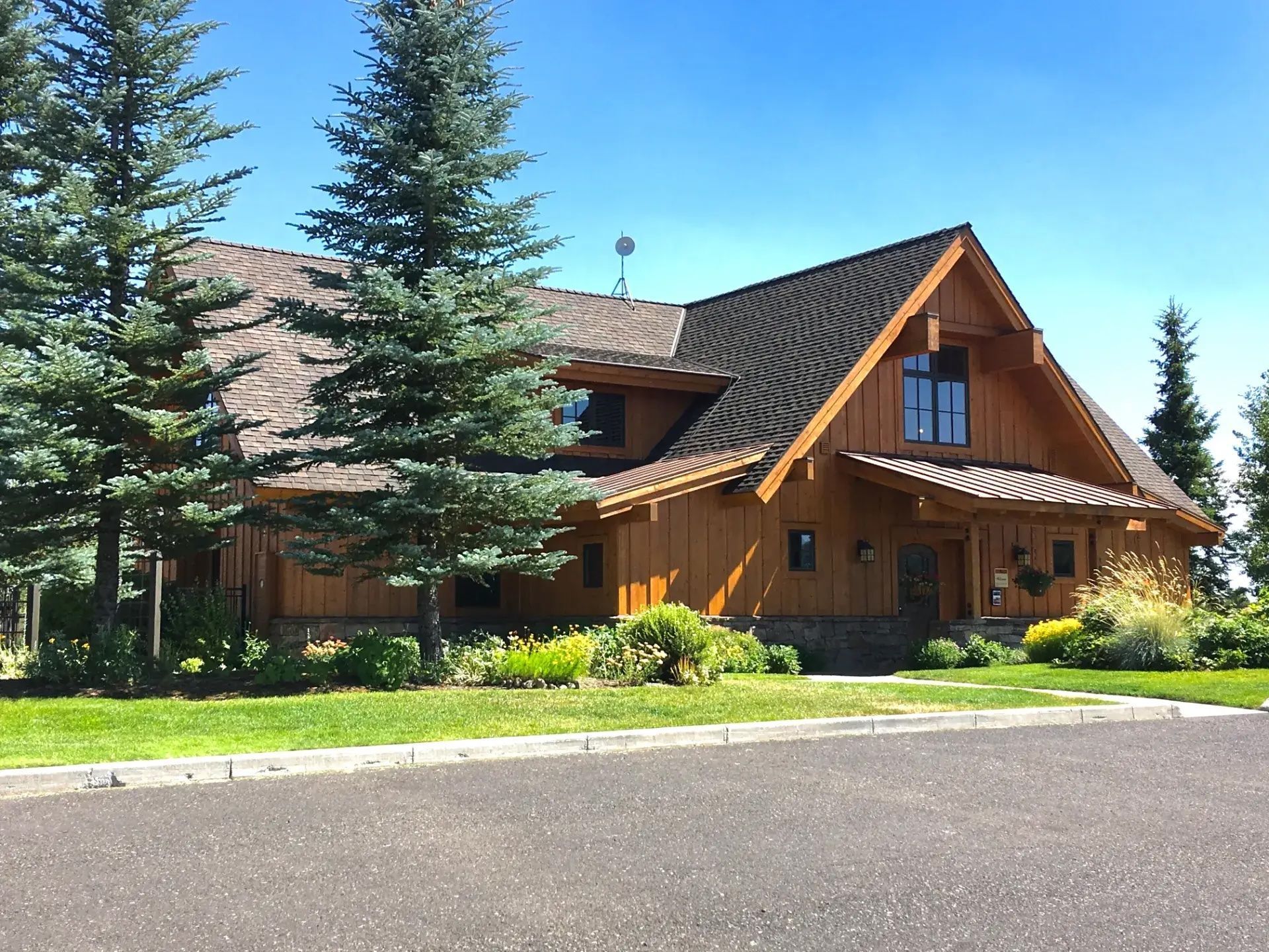 Side profile of luxury home with multi-plane roofline at golden hour