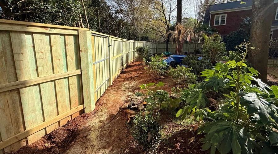 New wooden privacy fence bordering a Gaston County garden