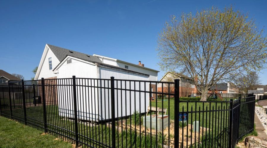 Black aluminum fence installed around a Gastonia backyard